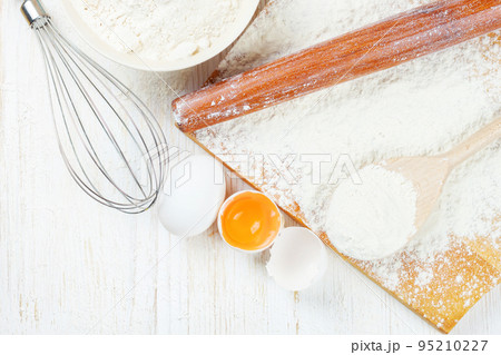 Baking ingredients on white wooden background 95210227