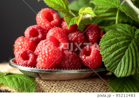 Raspberries in a small metal dish. Raspberries in a small metal dish. 95211483