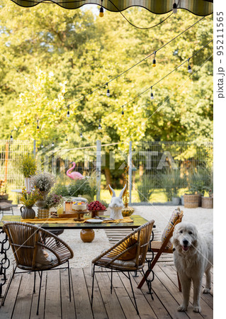 Cozy dining place on wooden terrace at backyard 95211565