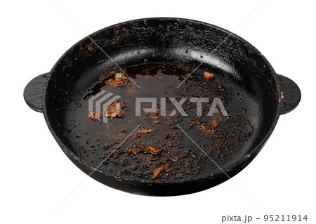 Dirty frying pan isolated on white background. A greasy dutch oven. 95211914