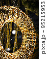 Christmas New Year holiday illumination. Glowing round golden garland on the background of the Christmas tree at night 95215953