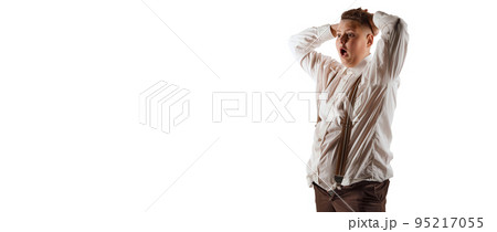Shocked teen boy, overweight model in white shirt and suspenders isolated over white studio background. Concept of youth, emotions, facial expressions 95217055