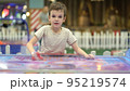 Boy trying to win in the game of air hockey on the playground 95219574