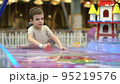 Joyful playful boy playing air hockey on the playground. Entertainment for children 95219576