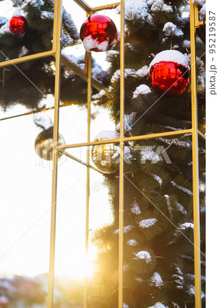 Close up of balls on christmas snowy tree. Christmas decorations. New Year concept. Winter holidays. Close up of balls on christmas snowy tree. Christmas decorations. New Year concept. Winter holidays. 95219587