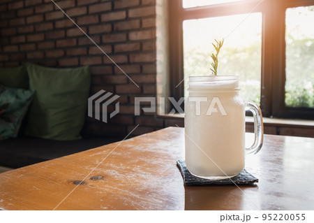 coconut water frappe with rosemary leaf on restaurant table 95220055