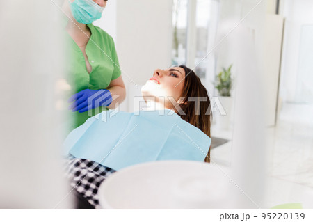 Dentist doing dental checkup for his patient. Dentist doing dental checkup for his patient. 95220139