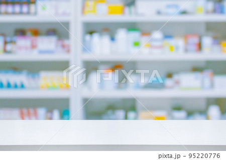 Empty white counter with pharmacy drugstore shelves blurred background 95220776
