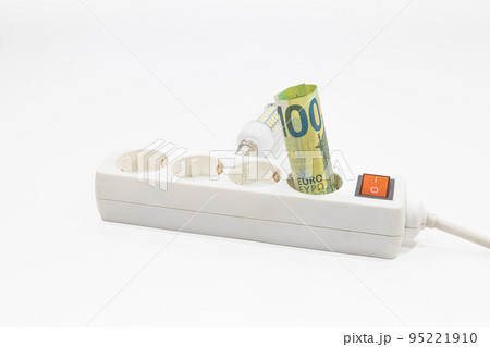 Euro banknotes are stuck in an electric power strip. Concept of the increasing electricity prices 95221910