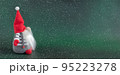 Christmas gnome in red hat holiday banner on dark green winter background 95223278