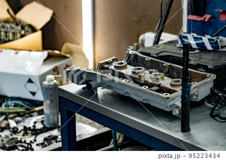 Disassembled car engine block at car service station 95223434