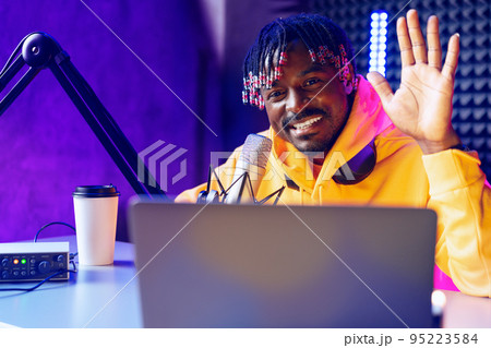 Happy young african man audio blogger broadcasting at studio 95223584