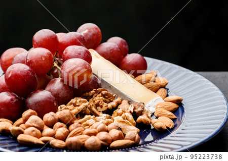 Close up of nuts and grapes on plate Close up of nuts and grapes on plate 95223738