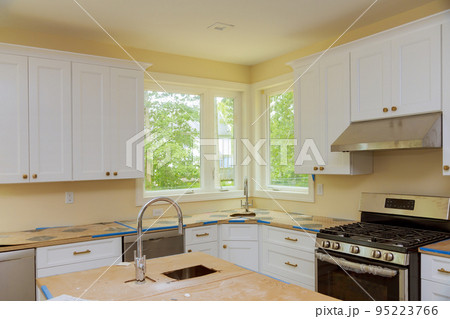 Installation kitchen cabinets with beautiful furniture such as drawers in new house 95223766