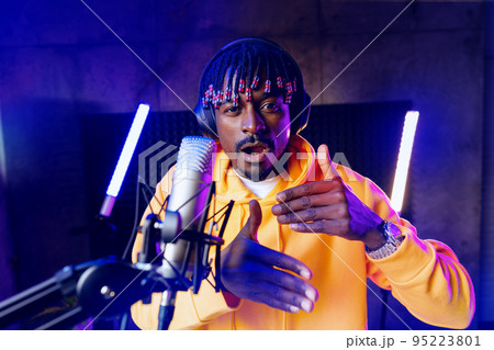 Young African performer recording his new track in recording studio Young African performer recording his new track in recording studio 95223801