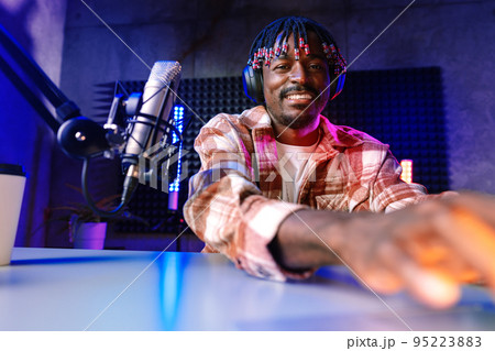 Happy young african man audio blogger broadcasting at studio Happy young african man audio blogger broadcasting at studio 95223883