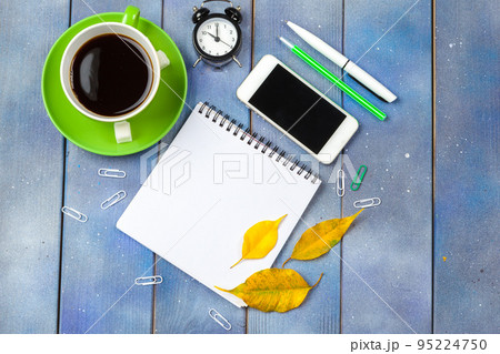Modern workplace with cup of coffee on wooden table Modern workplace with cup of coffee on wooden table 95224750