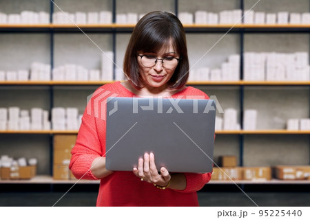 Warehouse woman picking online orders for shipping Warehouse woman picking online orders for shipping 95225440
