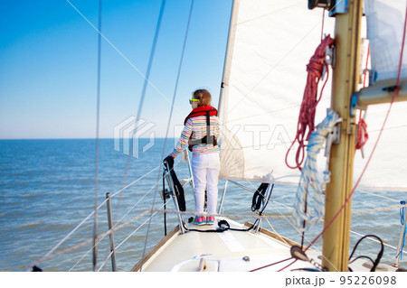 Kids sail on yacht in sea. Child sailing on boat. Kids sail on yacht in sea. Child sailing on boat. 95226098