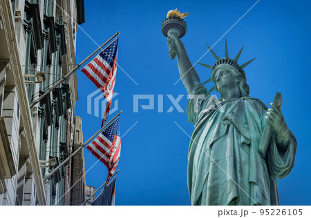 View Statue of Liberty near US building in flying flag United States America 95226105