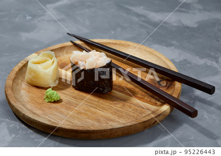 Warm rolls with tuna, salmon, perch, eel, tobiko caviar, nori, rice, cucumber on black background. 95226443