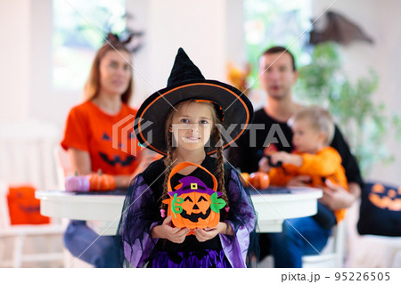 Family carving pumpkin. Halloween trick or treat 95226505