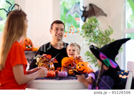 Family carving pumpkin. Halloween trick or treat Family carving pumpkin. Halloween trick or treat 95226506