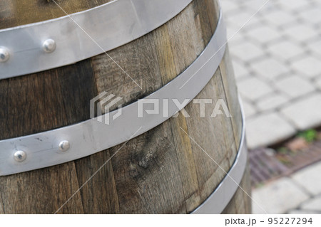 oak barrel with iron hoops close up on blurred background of city square oak barrel with iron hoops close up on blurred background of city square 95227294