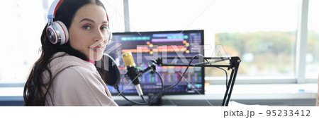 Disabled woman works as radio presenter in wheelchair in studio 95233412