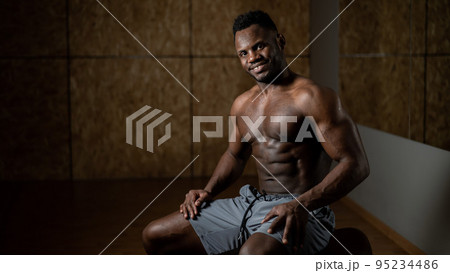 Handsome afro american shirtless man posing in the gym. Handsome afro american shirtless man posing in the gym. 95234486