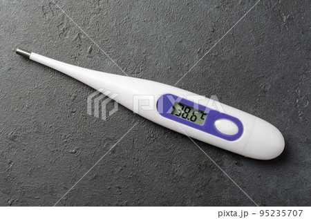 Medical electronic thermometer on a black background. High temperature. The concept of diagnosis of diseases. Medical electronic thermometer on a black background. High temperature. The concept of diagnosis of diseases. 95235707
