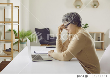 Unhappy mature woman have problems with computer 95235781