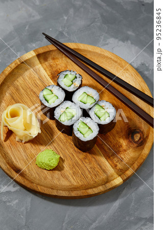 Sushi Maki rolls cucumber. Fresh hosomaki pieces with rice and nori. Close Up of delicious japanese food with sushi roll. 95236845