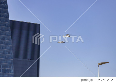 Helicopter. Airplane. Military vehicle. Spanish Air Force on the day of the National Holiday of October 12 flying over the streets of the city of Madrid. MADRID, SPAIN - OCTOBER 12, 2022. 95241212