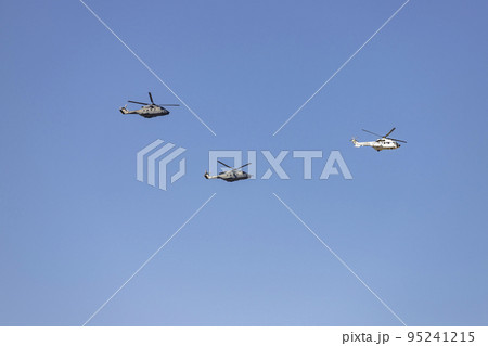 Helicopter. Airplane. Military vehicle. Spanish Air Force on the day of the National Holiday of October 12 flying over the streets of the city of Madrid. MADRID, SPAIN - OCTOBER 12, 2022. 95241215