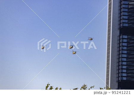 Helicopter. Airplane. Military vehicle. Spanish Air Force on the day of the National Holiday of October 12 flying over the streets of the city of Madrid. MADRID, SPAIN - OCTOBER 12, 2022. Helicopter. Airplane. Military vehicle. Spanish Air Force on the day of the National Holiday of October 12 flying over the streets of the city of Madrid. MADRID, SPAIN - OCTOBER 12, 2022. 95241221