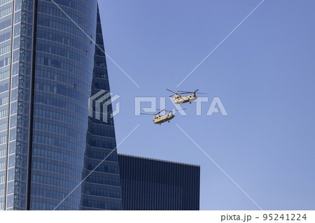 Helicopter. Airplane. Military vehicle. Spanish Air Force on the day of the National Holiday of October 12 flying over the streets of the city of Madrid. MADRID, SPAIN - OCTOBER 12, 2022. 95241224