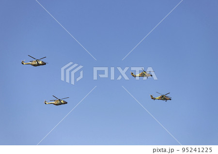 Helicopter. Airplane. Military vehicle. Spanish Air Force on the day of the National Holiday of October 12 flying over the streets of the city of Madrid. MADRID, SPAIN - OCTOBER 12, 2022. 95241225