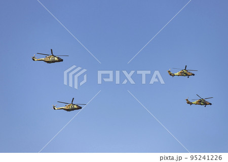 Helicopter. Airplane. Military vehicle. Spanish Air Force on the day of the National Holiday of October 12 flying over the streets of the city of Madrid. MADRID, SPAIN - OCTOBER 12, 2022. 95241226