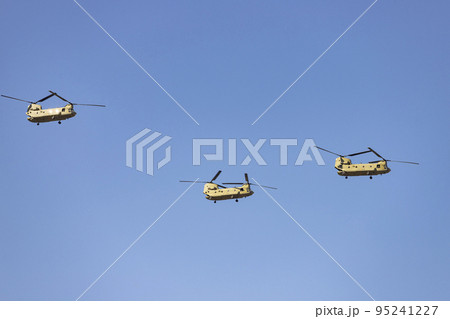 Helicopter. Airplane. Military vehicle. Spanish Air Force on the day of the National Holiday of October 12 flying over the streets of the city of Madrid. MADRID, SPAIN - OCTOBER 12, 2022. 95241227