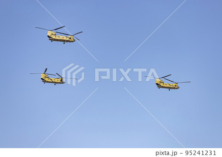 Helicopter. Airplane. Military vehicle. Spanish Air Force on the day of the National Holiday of October 12 flying over the streets of the city of Madrid. MADRID, SPAIN - OCTOBER 12, 2022. 95241231