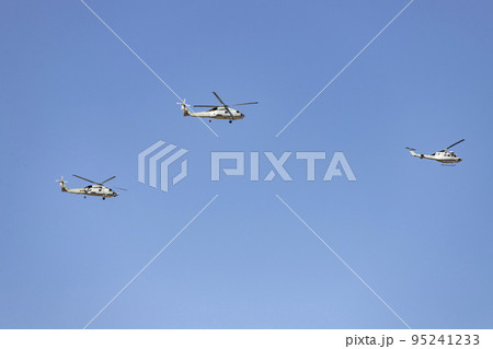 Helicopter. Airplane. Military vehicle. Spanish Air Force on the day of the National Holiday of October 12 flying over the streets of the city of Madrid. MADRID, SPAIN - OCTOBER 12, 2022. Helicopter. Airplane. Military vehicle. Spanish Air Force on the day of the National Holiday of October 12 flying over the streets of the city of Madrid. MADRID, SPAIN - OCTOBER 12, 2022. 95241233