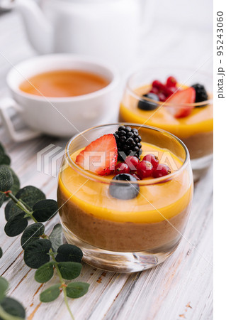 Delicious panna cotta with mango with berries 95243060