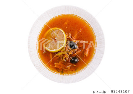 Solyanka mix soup with sausages, olives and lemon 95243107