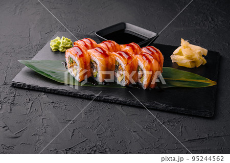 Delicious philadelphia sushi on black stone plate 95244562