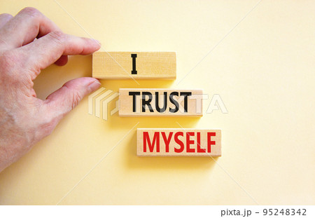 I trust myself symbol. Concept words I trust myself on wooden blocks. Businessman hand. Beautiful white table white background. Business, psychological and I trust myself concept. Copy space. 95248342