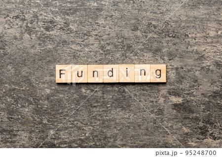 funding word written on wood block. funding text on table, concept 95248700