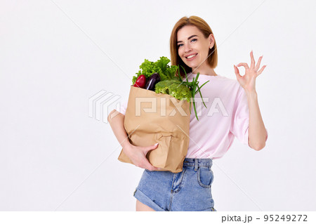 caucasian woman hold paper bag with vegetables 95249272