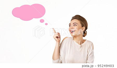 smiling young beautiful woman pointing up 95249403