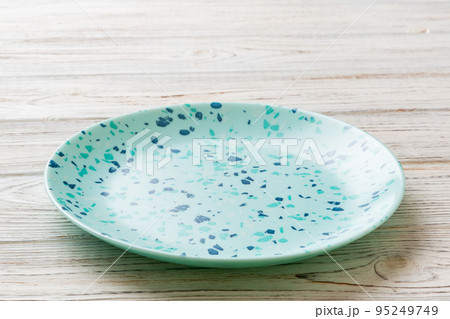 Perspective view of empty blue plate on wooden background. Empty space for your design 95249749
